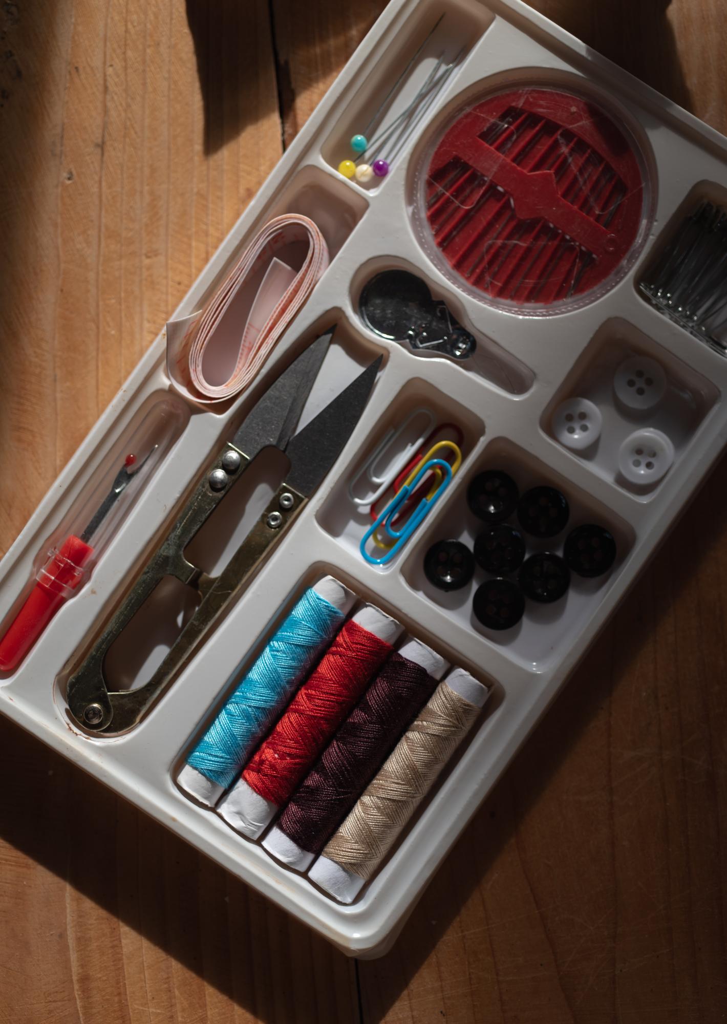 atelier workspace with threads, hoops and tools in neat layout