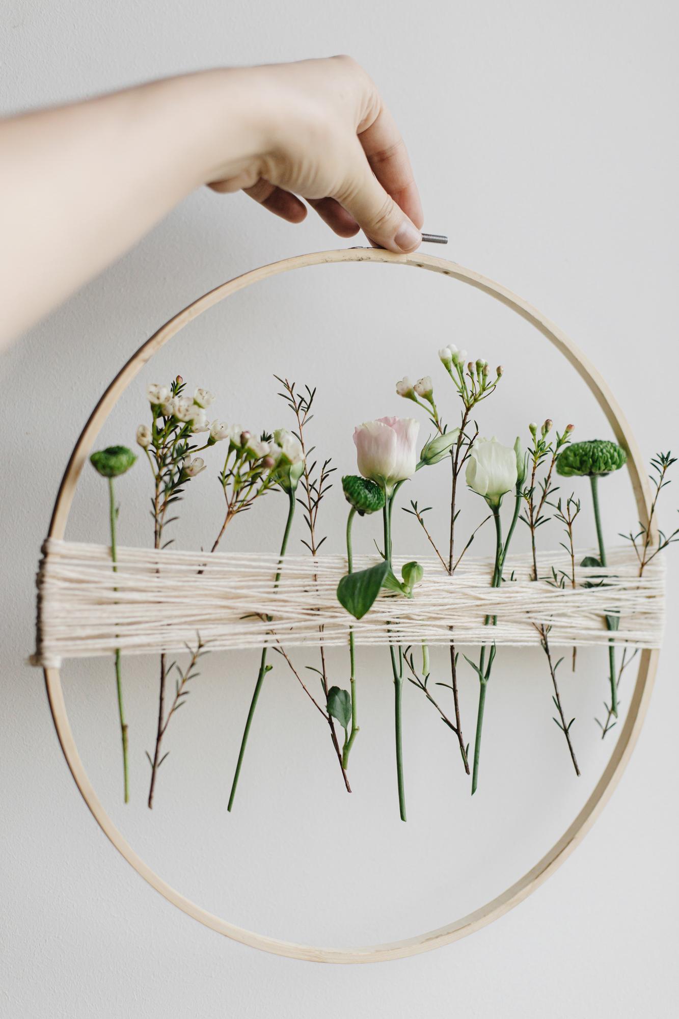 student stitching modern floral embroidery on hoop